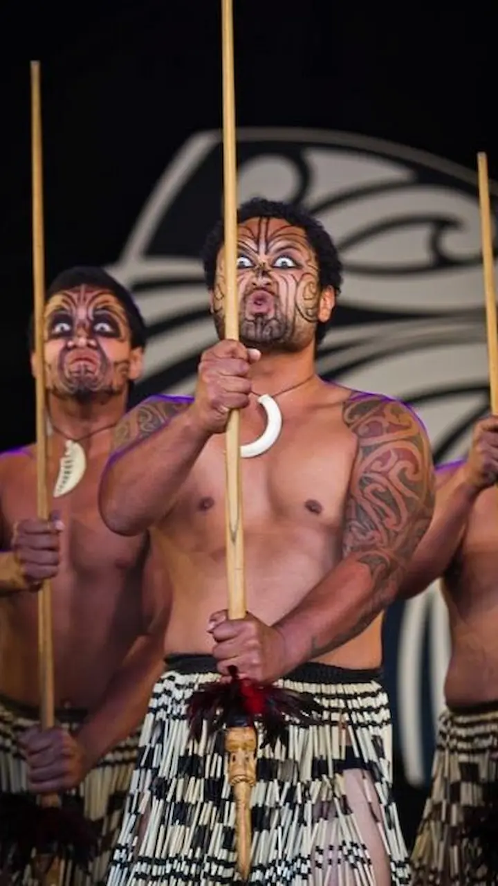 Haka performers with making terrifying facial expressions.