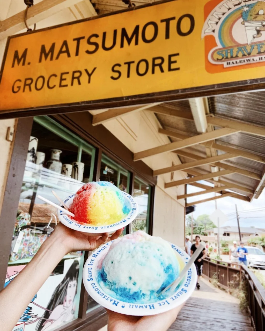 Two bowls of Matsumoto shave ice taken in from of M. Matsumoto entrance sign.