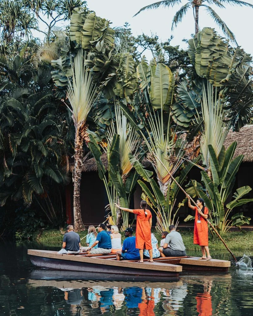 Guides giving a tour to guests on a canoe.