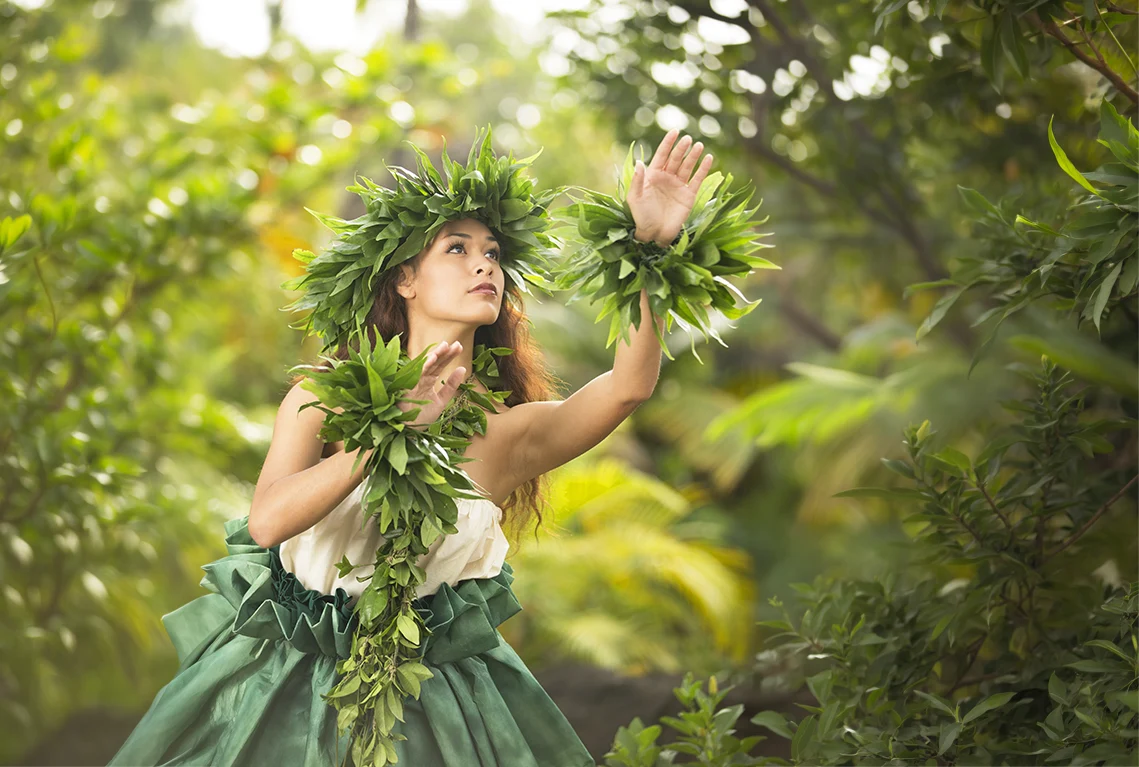 Traditional Hawaiian female hula dancer performing in authentic island village attire on Hawaii Island