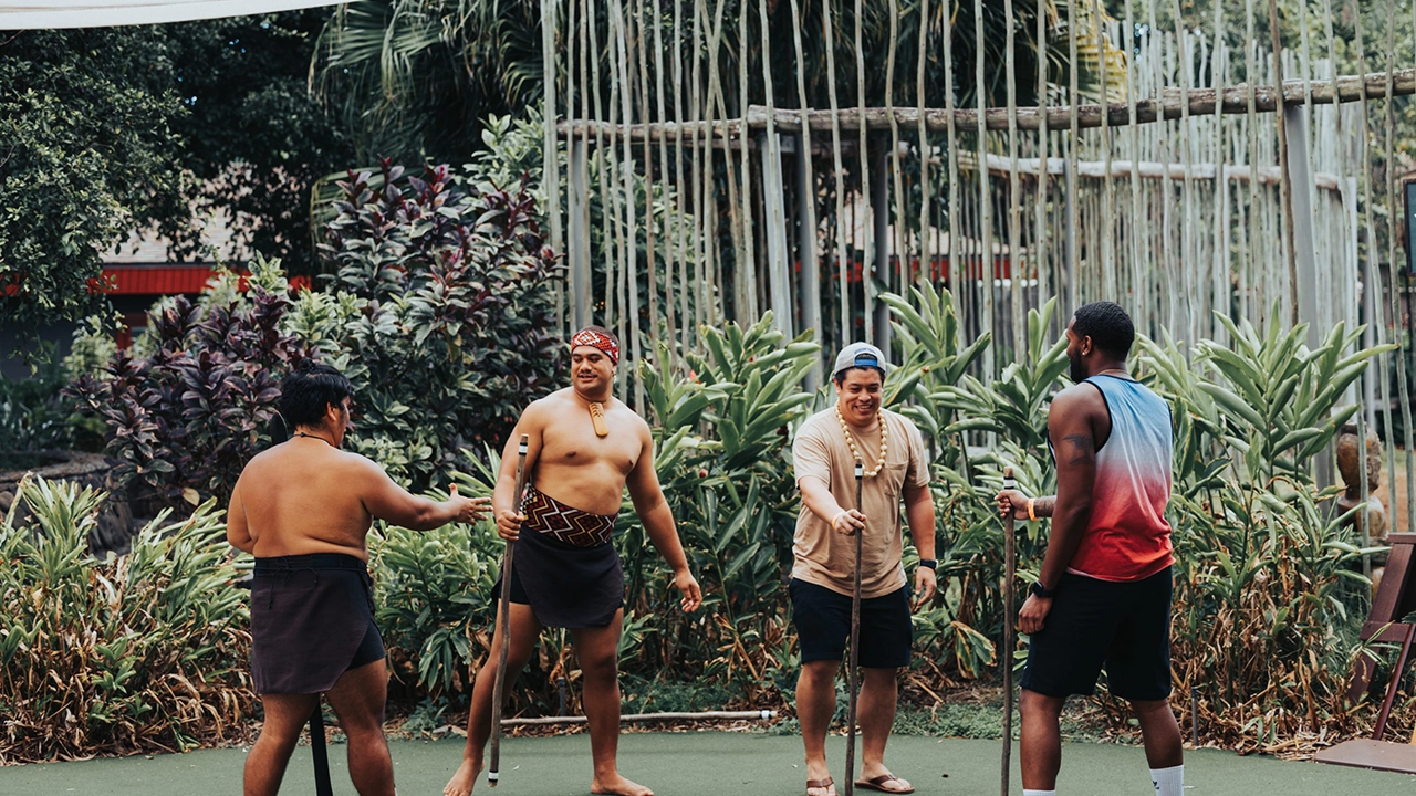 Māori village performers teaching guests.