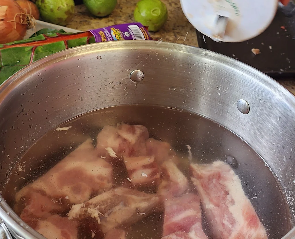 Boiling meat in a large pot for the boil-up.