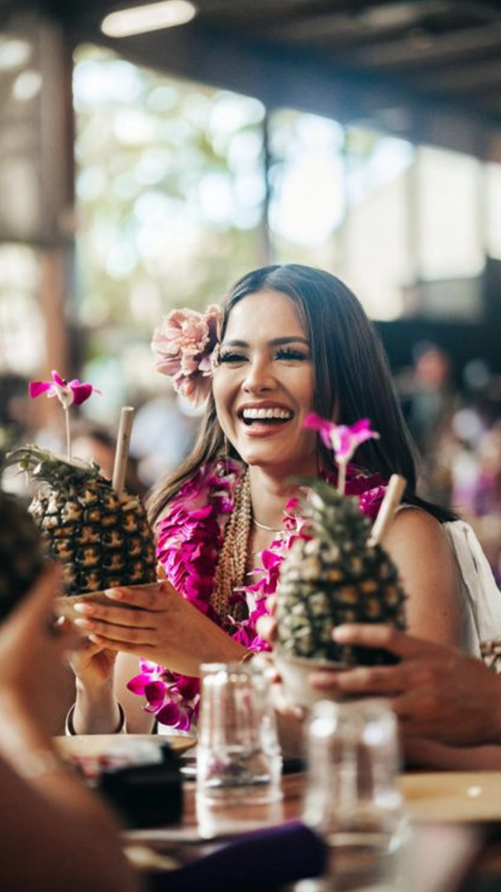 Image of Courtney Chung, Miss Hawaii, 2021 Miss Hawaii 2021, Courtney Chung enjoying her pi&ntilde;a colada at the Ali&rsquo;i Luau, served in a fresh pineapple shell. Photo by Polynesian Cultural Center.