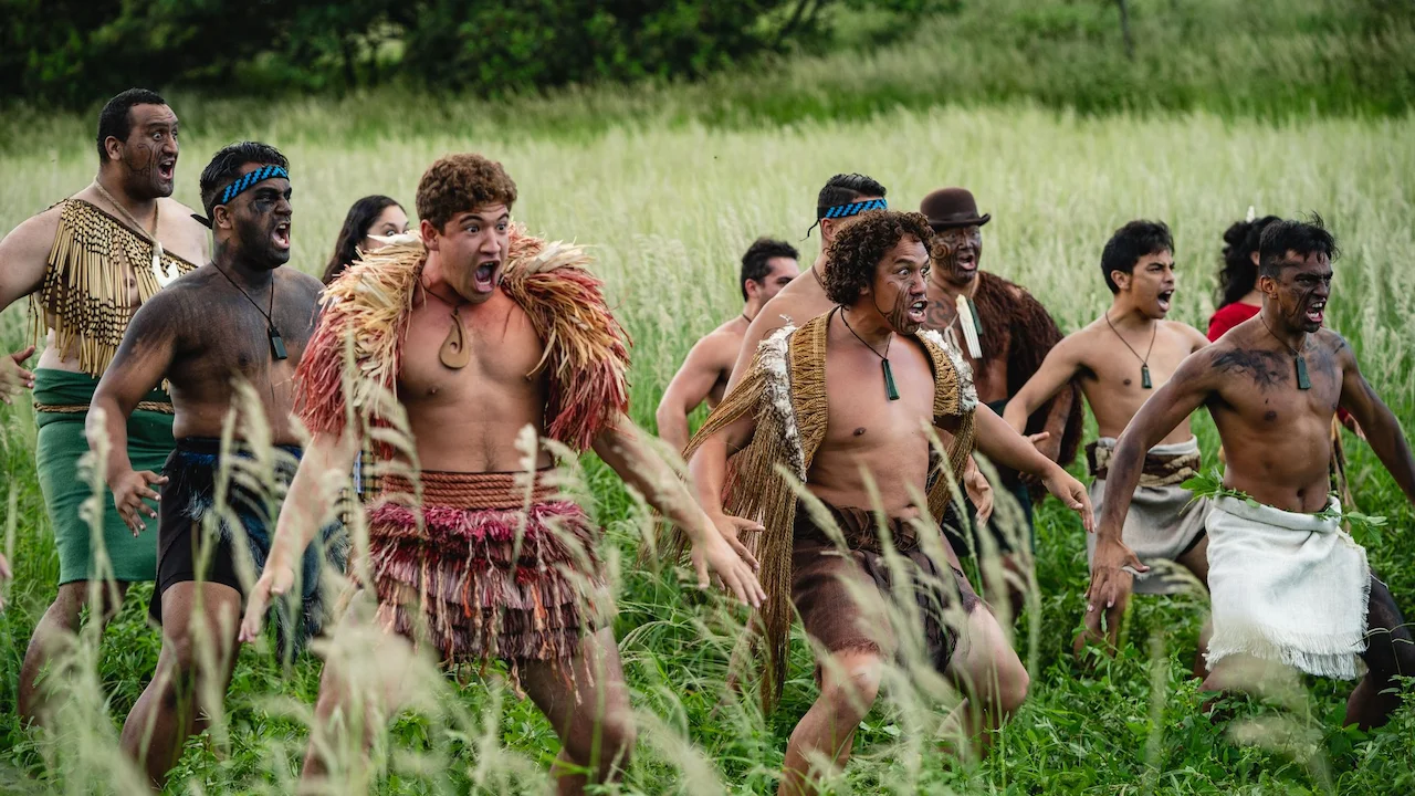 Men and women performing a fierce haka.