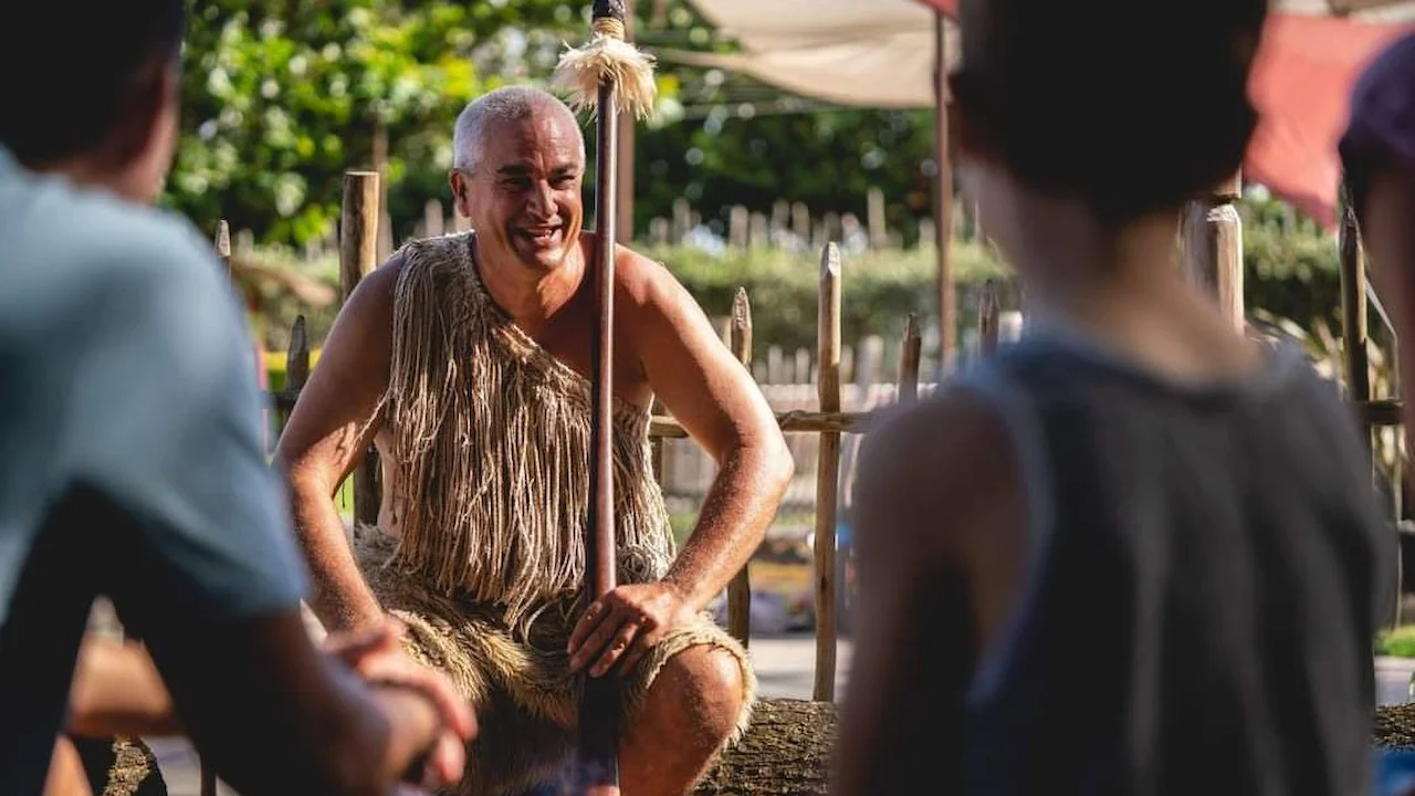 Māori performer at the Polynesian Cultural Center speaking to guests.