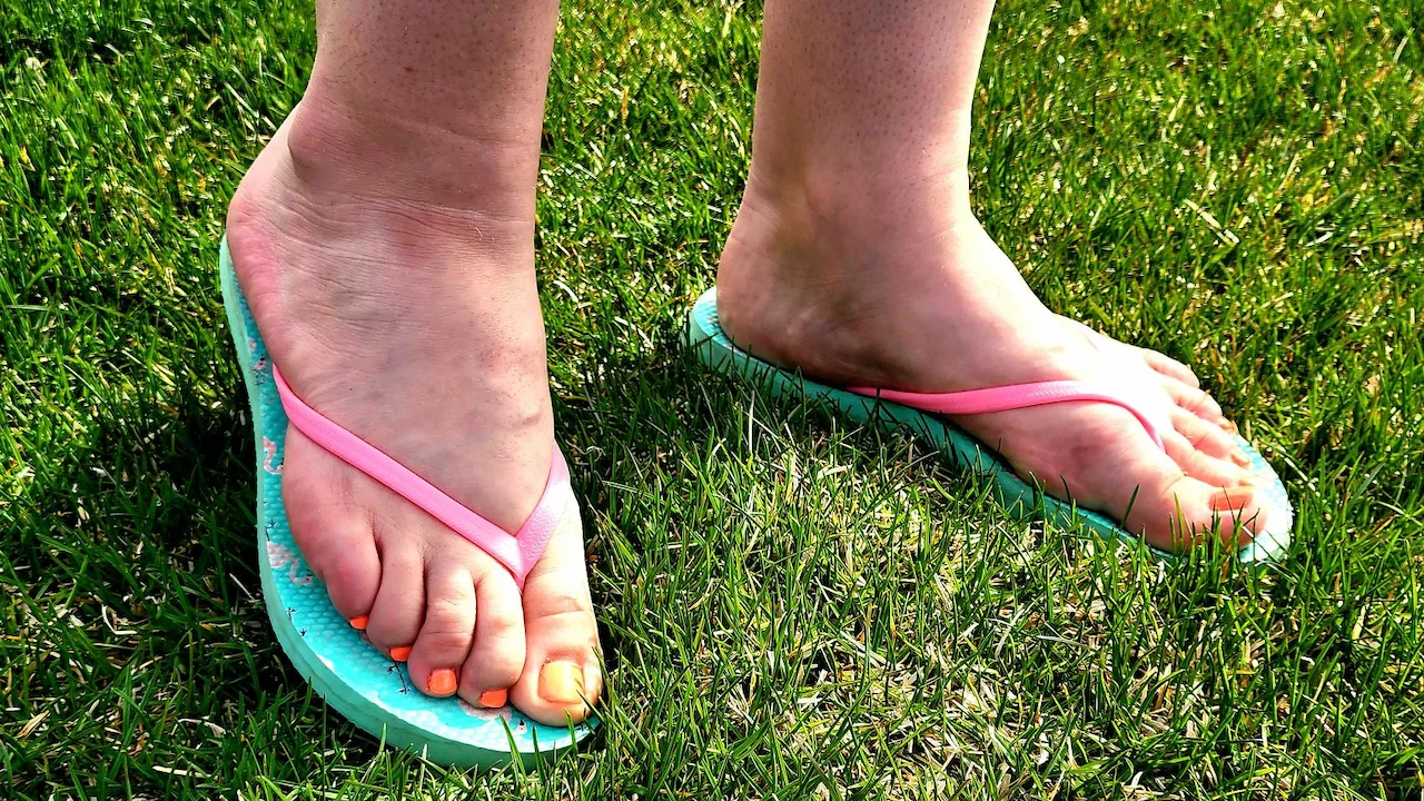 Pink and teal colored flip flop footwear