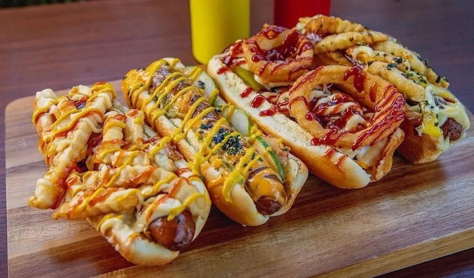 Hot dogs dressed with an variety of different toppings.