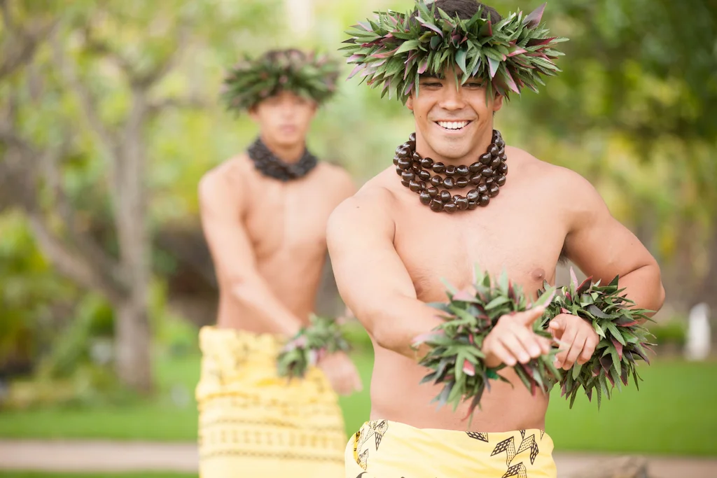Male hula dancers showcase the Hawaiian word Hoʻolauleʻa through the hula movements