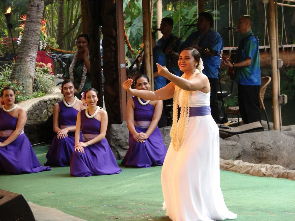 Graceful young lady showcasing the Hawaiian word Mahalo through her mesmerizing hula movements at the Aliʻi Lūʻau.