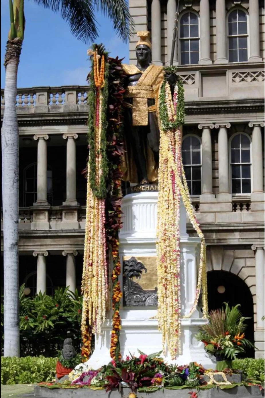 A statue of King Kamehameha I in front of the legislative buildings of Hawaii is draped in flowers every June 11 in commemoration of Kamehameha Day.