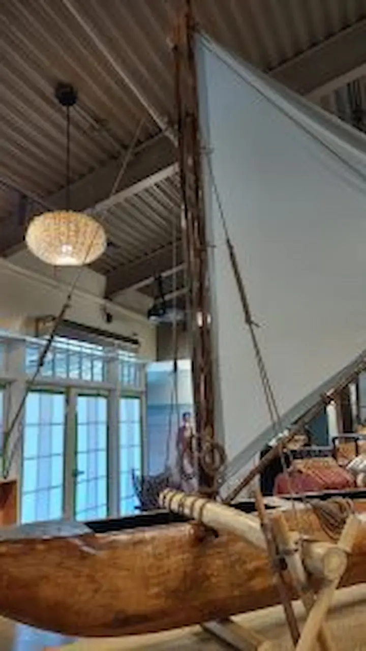 Large model replica of a double-hull canoe.