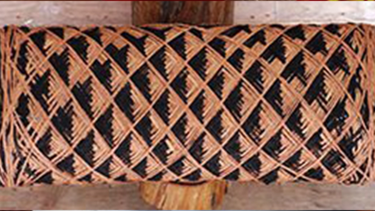 Brown and black geometric patterns shown made with braids.