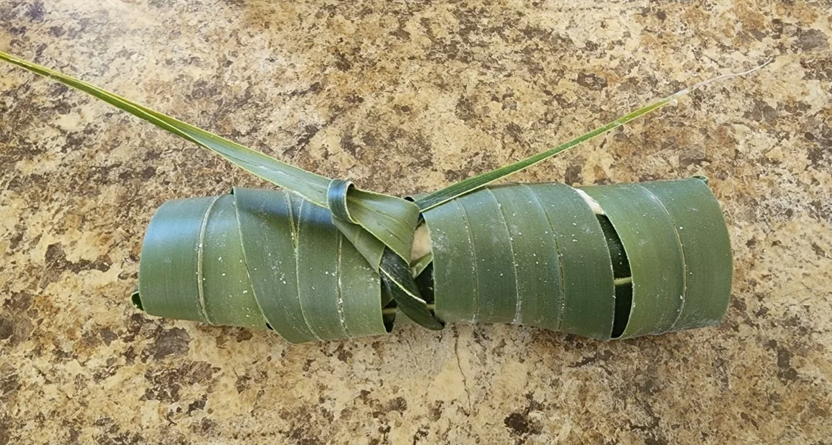 Tahitian coconut bread wrapped in coconut fronds 
