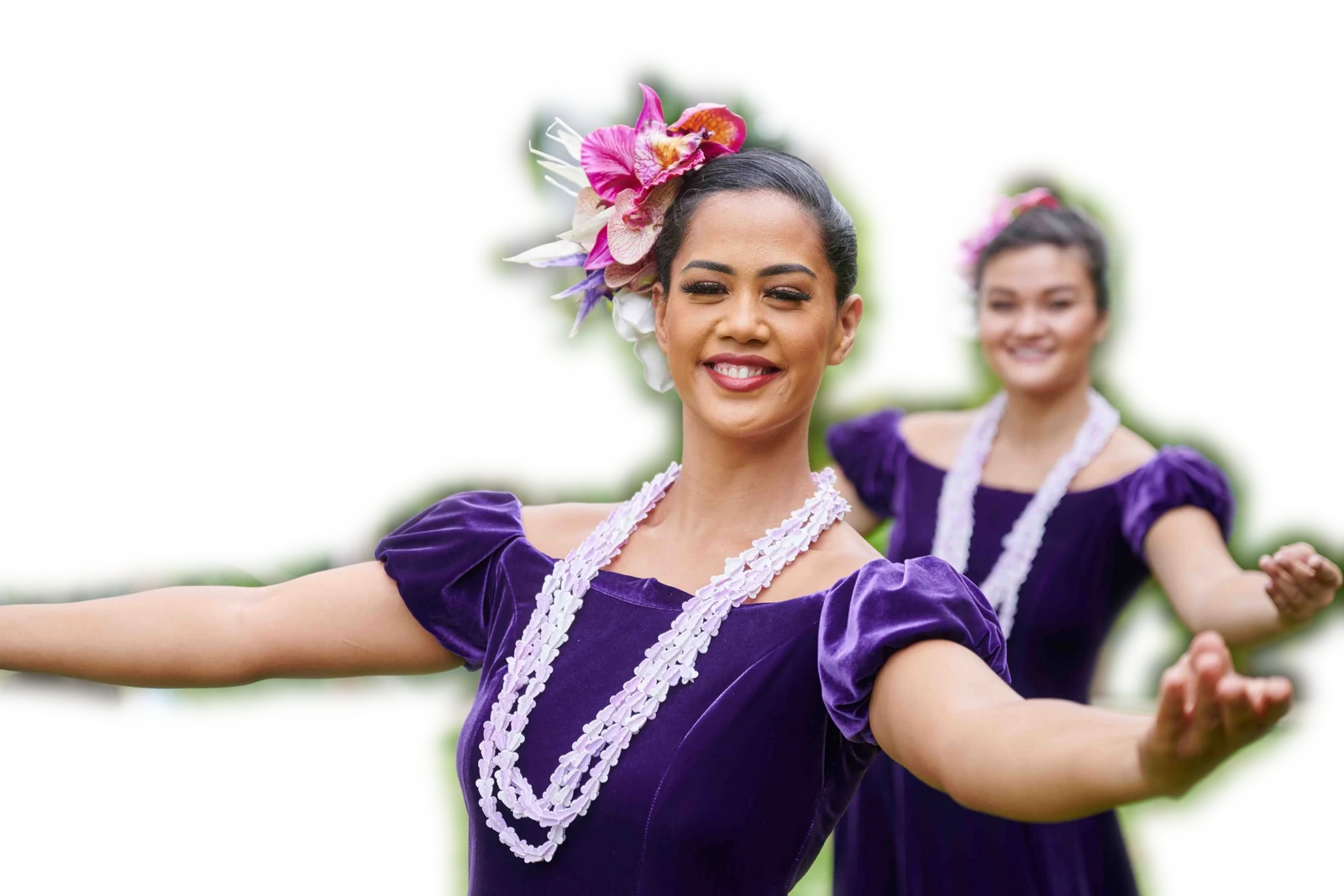Two PCC hula dancers in purple velvet holokū and white lei, arms outstretched